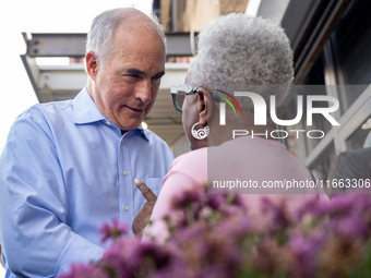 Sen. Bob Casey (D-PA) speaks to a woman outside a campaign rally in Philadelphia, Pennsylvania, United States, on October 13, 2024. (