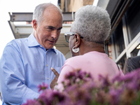 Sen. Bob Casey (D-PA) speaks to a woman outside a campaign rally in Philadelphia, Pennsylvania, United States, on October 13, 2024. (