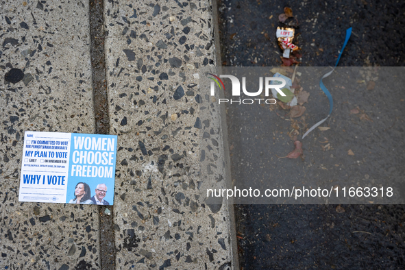 A voter pamphlet lies on the ground outside a campaign event in Philadelphia, Pennsylvania, United States, on October 13, 2024. 