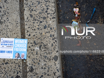 A voter pamphlet lies on the ground outside a campaign event in Philadelphia, Pennsylvania, United States, on October 13, 2024. (