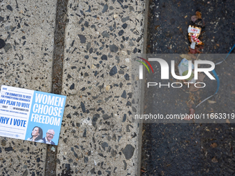 A voter pamphlet lies on the ground outside a campaign event in Philadelphia, Pennsylvania, United States, on October 13, 2024. (