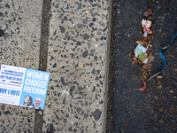 A voter pamphlet lies on the ground outside a campaign event in Philadelphia, Pennsylvania, United States, on October 13, 2024. (