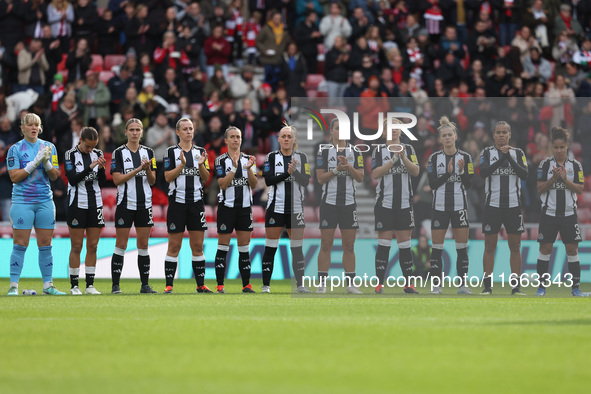 Newcastle's team joins in the applause for former club photographer Colin Lock, who passed away recently, during the FA Women's Championship...