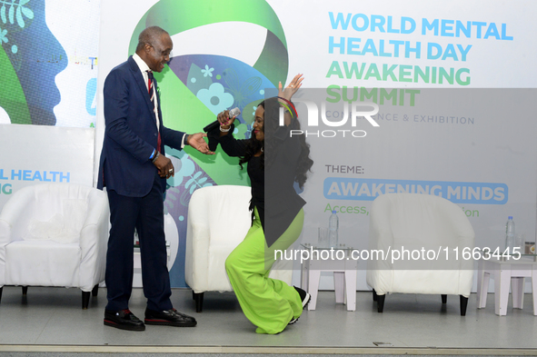 Eniola Bello, founder of Mindsplace and convener of the World Mental Health Day Awakening Summit, greets Femi Olubanwo, a lawyer and Chairma...