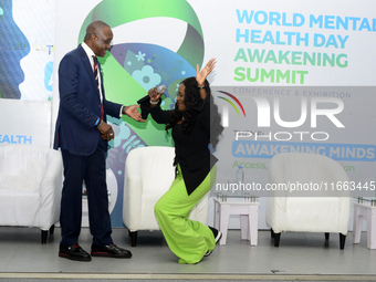 Eniola Bello, founder of Mindsplace and convener of the World Mental Health Day Awakening Summit, greets Femi Olubanwo, a lawyer and Chairma...