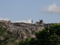 A man walks in a dump site at Olusosun during the summit to discuss ''Mental Health at Work'' in commemoration of 2024 World Mental Health D...