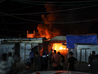 Rescuers work at the site of an Israeli strike on tents sheltering displaced people amid the Israel-Hamas conflict in Deir Al-Balah, Gaza St...