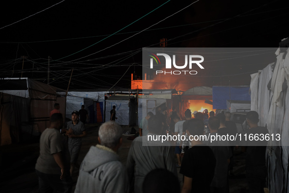 Rescuers work at the site of an Israeli strike on tents sheltering displaced people amid the Israel-Hamas conflict in Deir Al-Balah, Gaza St...