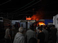 Rescuers work at the site of an Israeli strike on tents sheltering displaced people amid the Israel-Hamas conflict in Deir Al-Balah, Gaza St...