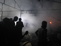 Rescuers work at the site of an Israeli strike on tents sheltering displaced people amid the Israel-Hamas conflict in Deir Al-Balah, Gaza St...