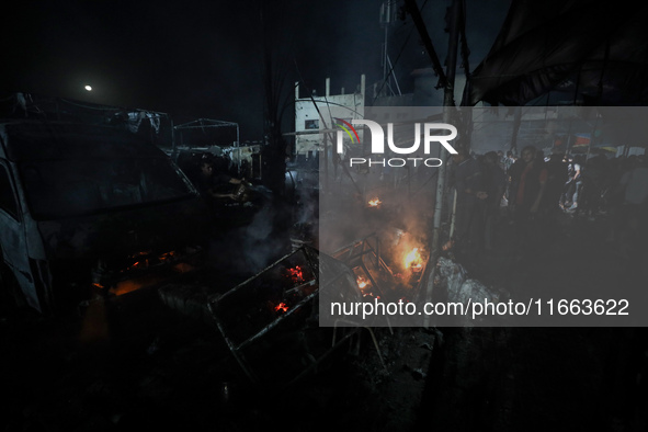 Rescuers work at the site of an Israeli strike on tents sheltering displaced people amid the Israel-Hamas conflict in Deir Al-Balah, Gaza St...