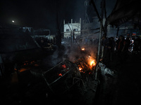 Rescuers work at the site of an Israeli strike on tents sheltering displaced people amid the Israel-Hamas conflict in Deir Al-Balah, Gaza St...