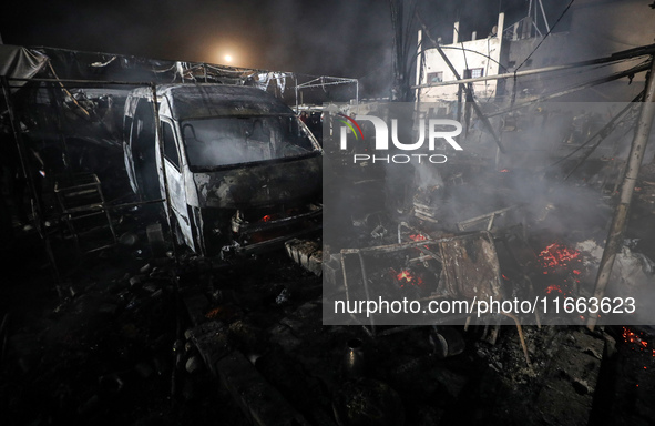 Rescuers work at the site of an Israeli strike on tents sheltering displaced people amid the Israel-Hamas conflict in Deir Al-Balah, Gaza St...