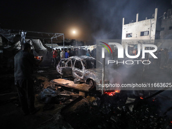 Rescuers work at the site of an Israeli strike on tents sheltering displaced people amid the Israel-Hamas conflict in Deir Al-Balah, Gaza St...