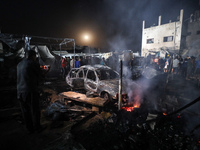 Rescuers work at the site of an Israeli strike on tents sheltering displaced people amid the Israel-Hamas conflict in Deir Al-Balah, Gaza St...