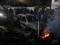 Rescuers work at the site of an Israeli strike on tents sheltering displaced people amid the Israel-Hamas conflict in Deir Al-Balah, Gaza St...