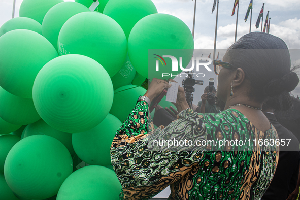 Dr. Kemi Ogunyemi, Special Adviser on Health to the Governor, Lagos State, attaches a card with words of hope to the ceremonial green balloo...