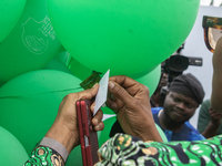 Dr. Kemi Ogunyemi, Special Adviser on Health to the Governor, Lagos State, attaches a card with words of hope to the ceremonial green balloo...