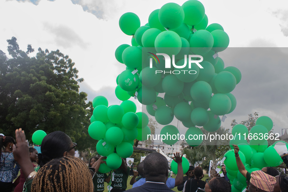 Ceremonial green balloons, symbolizing hope and resilience in the face of mental health challenges, are released during the launch of the ne...