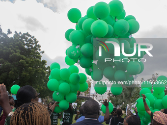 Ceremonial green balloons, symbolizing hope and resilience in the face of mental health challenges, are released during the launch of the ne...