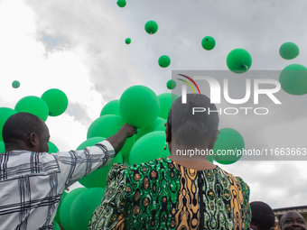 Ceremonial green balloons, symbolizing hope and resilience in the face of mental health challenges, are released during the launch of the ne...