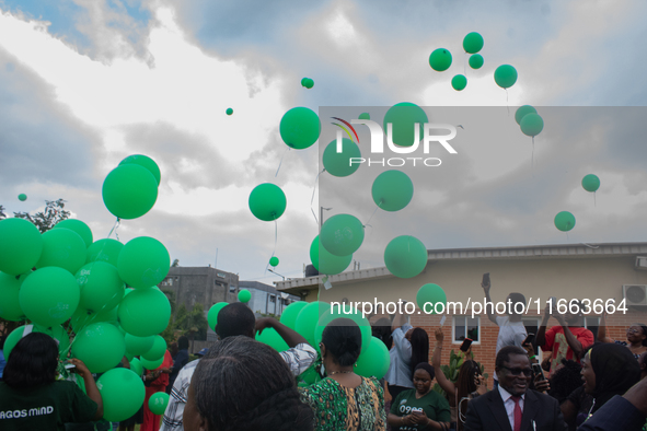 Ceremonial green balloons, symbolizing hope and resilience in the face of mental health challenges, are released during the launch of the ne...