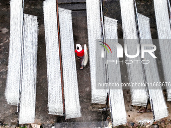 Villagers dry their noodles on wooden tanning racks in front and back of their farmhouses in Fuzhou, China, on October 13, 2024. (