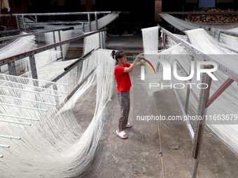 Villagers dry their noodles on wooden tanning racks in front and back of their farmhouses in Fuzhou, China, on October 13, 2024. (