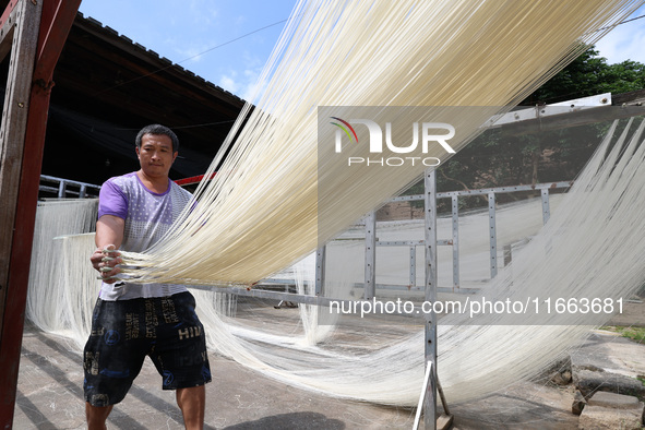 Villagers dry their noodles on wooden tanning racks in front and back of their farmhouses in Fuzhou, China, on October 13, 2024. 