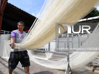 Villagers dry their noodles on wooden tanning racks in front and back of their farmhouses in Fuzhou, China, on October 13, 2024. (