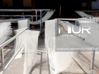 Villagers dry their noodles on wooden tanning racks in front and back of their farmhouses in Fuzhou, China, on October 13, 2024. (