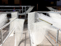 Villagers dry their noodles on wooden tanning racks in front and back of their farmhouses in Fuzhou, China, on October 13, 2024. (