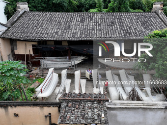 Villagers dry their noodles on wooden tanning racks in front and back of their farmhouses in Fuzhou, China, on October 13, 2024. (