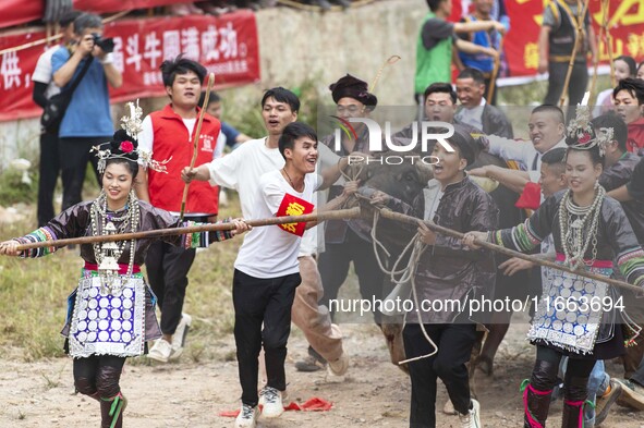 People watch a bullfight at a bullfighting pond in Congjiang County, Guizhou Province, China, on October 13, 2024. 