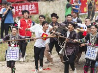 People watch a bullfight at a bullfighting pond in Congjiang County, Guizhou Province, China, on October 13, 2024. (