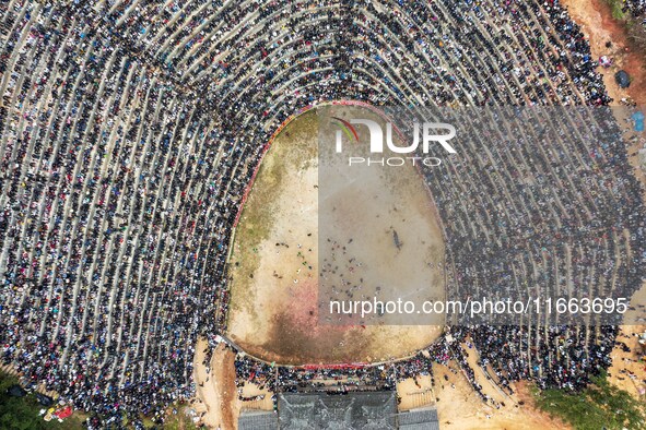 People watch a bullfight at a bullfighting pond in Congjiang County, Guizhou Province, China, on October 13, 2024. 