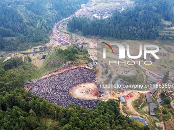 People watch a bullfight at a bullfighting pond in Congjiang County, Guizhou Province, China, on October 13, 2024. (