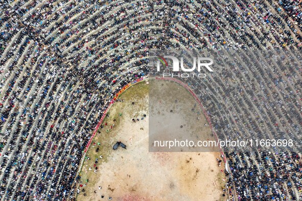 People watch a bullfight at a bullfighting pond in Congjiang County, Guizhou Province, China, on October 13, 2024. 