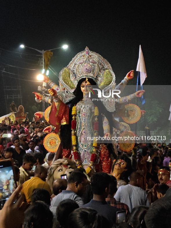 Devotees immerse Durga idols at the Mahananda River on the last day of the Dushhera-Vijaya Dashami festival on the final day of Durga Puja i...