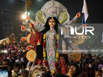 Devotees immerse Durga idols at the Mahananda River on the last day of the Dushhera-Vijaya Dashami festival on the final day of Durga Puja i...