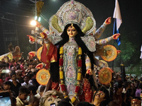 Devotees immerse Durga idols at the Mahananda River on the last day of the Dushhera-Vijaya Dashami festival on the final day of Durga Puja i...