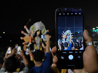 Devotees immerse Durga idols at the Mahananda River on the last day of the Dushhera-Vijaya Dashami festival on the final day of Durga Puja i...