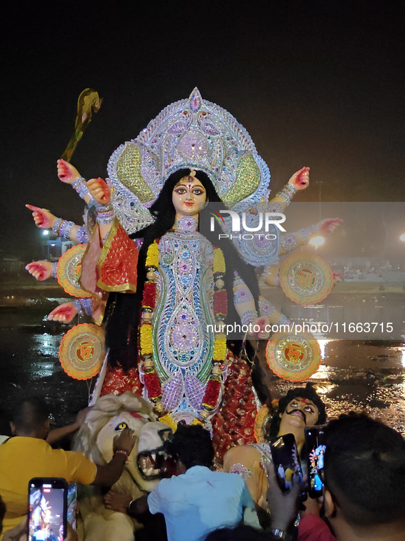 Devotees immerse Durga idols at the Mahananda River on the last day of the Dushhera-Vijaya Dashami festival on the final day of Durga Puja i...