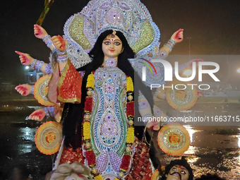 Devotees immerse Durga idols at the Mahananda River on the last day of the Dushhera-Vijaya Dashami festival on the final day of Durga Puja i...