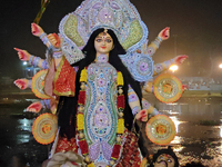 Devotees immerse Durga idols at the Mahananda River on the last day of the Dushhera-Vijaya Dashami festival on the final day of Durga Puja i...