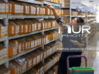 Workers sort goods at an e-commerce base in Jinhua, China, on October 14, 2024. On the same day, major e-commerce companies in China open th...