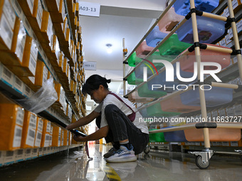 Workers sort goods at an e-commerce base in Jinhua, China, on October 14, 2024. On the same day, major e-commerce companies in China open th...