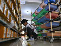 Workers sort goods at an e-commerce base in Jinhua, China, on October 14, 2024. On the same day, major e-commerce companies in China open th...