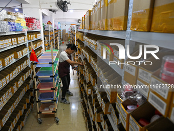 Workers sort goods at an e-commerce base in Jinhua, China, on October 14, 2024. On the same day, major e-commerce companies in China open th...