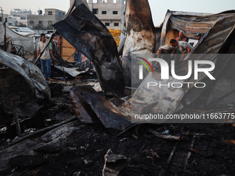 A Palestinian boy looks at the site of an Israeli strike on tents sheltering displaced people amid the Israel-Hamas conflict at Al-Aqsa Mart...